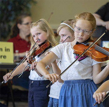 Three Girls playing violin