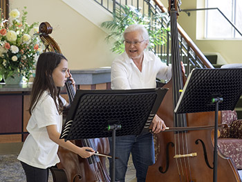 student-teacher playing bass