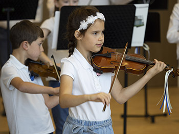 Girl in white playing violin