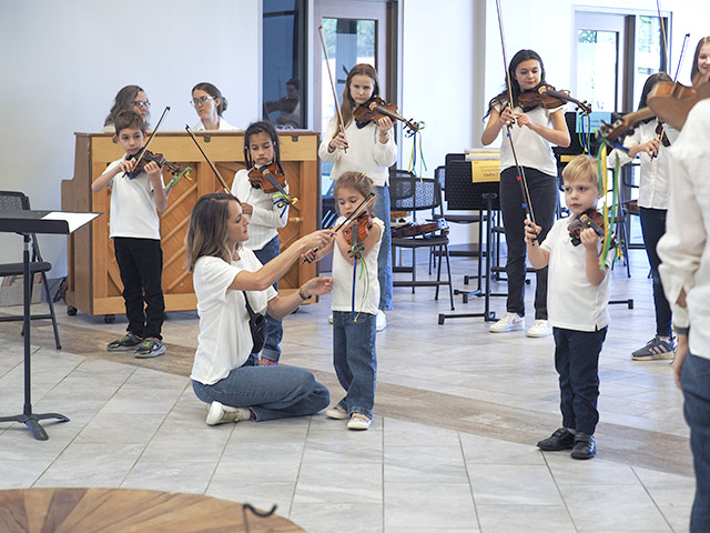 small children playing violin