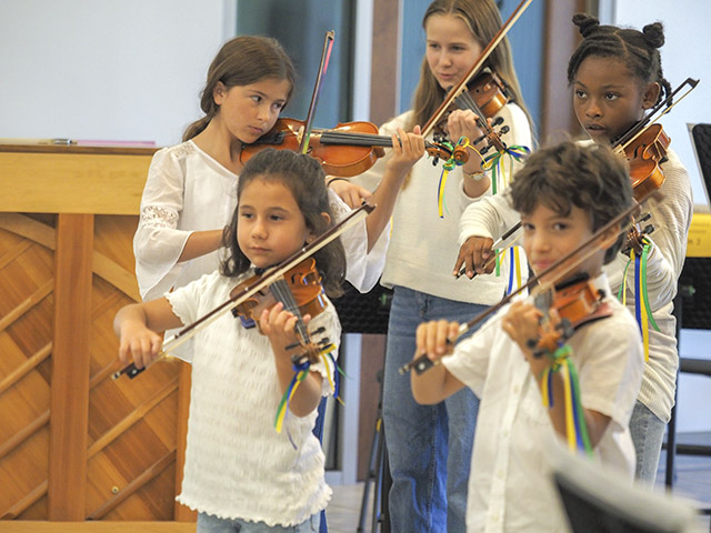 Five children playing violin