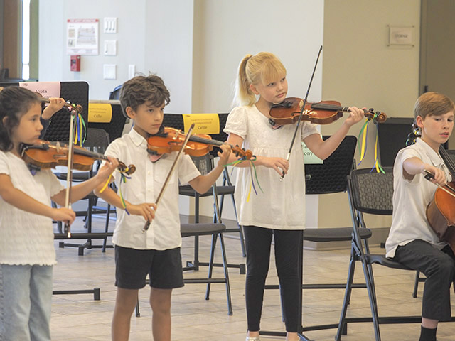 two children playing violin