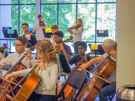 children playing cellos